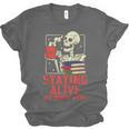 Staying Alive One Book At A Time Skeleton Reading Librarian Unisex Jersey T-Shirt