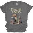 Women's Unearth A Story Dinosaur Reading a Library Book Unisex Jersey T-Shirt