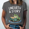 Unearth a Story Frog Reading a Book Summer 2026 Unisex Jersey T-Shirt Unearth a Story Frog Reading a Book Summer 2026 Unisex Jersey T-Shirt