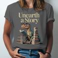 Women's Unearth A Story Dinosaur Reading a Library Book Unisex Jersey T-Shirt