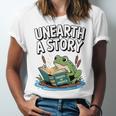 Unearth a Story Frog Reading a Book Summer 2026 Premium Tri-Blend Unisex Jersey T-Shirt Unearth a Story Frog Reading a Book Summer 2026 Premium Tri-Blend Unisex Jersey T-Shirt