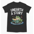 Unearth a Story Frog Reading a Book Summer 2026 Unisex T-Shirt Unearth a Story Frog Reading a Book Summer 2026 Unisex T-Shirt