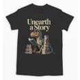 Women's Unearth A Story Dinosaur Reading a Library Book Unisex T-Shirt Women's Unearth A Story Dinosaur Reading a Library Book Unisex T-Shirt
