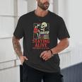 Staying Alive One Book At A Time Skeleton Reading Librarian Unisex T-Shirt
