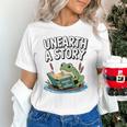 Unearth a Story Frog Reading a Book Summer 2026 Premium Tri-Blend Unisex T-Shirt