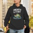 Unearth a Story Frog Reading a Book Summer 2026 Unisex Hoodie