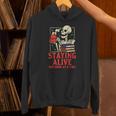 Staying Alive One Book At A Time Skeleton Reading Librarian Unisex Hoodie Staying Alive One Book At A Time Skeleton Reading Librarian Unisex Hoodie