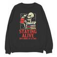 Staying Alive One Book At A Time Skeleton Reading Librarian Unisex Sweatshirt Staying Alive One Book At A Time Skeleton Reading Librarian Unisex Sweatshirt