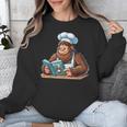 Bigfoot Reading a Cookbook Unisex Sweatshirt
