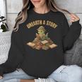 Unearth a Story Dinosaur Reading Books Summer 2026 Unisex Sweatshirt Unearth a Story Dinosaur Reading Books Summer 2026 Unisex Sweatshirt
