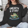 Unearth a Story Frog Reading a Book Summer 2026 Unisex Sweatshirt Unearth a Story Frog Reading a Book Summer 2026 Unisex Sweatshirt