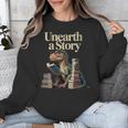 Women's Unearth A Story Dinosaur Reading a Library Book Unisex Sweatshirt Women's Unearth A Story Dinosaur Reading a Library Book Unisex Sweatshirt