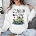 Unearth a Story Frog Reading a Book Summer 2026 Premium Tri-Blend Unisex Sweatshirt Unearth a Story Frog Reading a Book Summer 2026 Premium Tri-Blend Unisex Sweatshirt