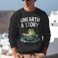 Unearth a Story Frog Reading a Book Summer 2026 Unisex Sweatshirt Unearth a Story Frog Reading a Book Summer 2026 Unisex Sweatshirt