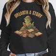 Unearth a Story Dinosaur Reading Books Summer 2026 Unisex Sweatshirt Unearth a Story Dinosaur Reading Books Summer 2026 Unisex Sweatshirt