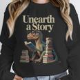 Women's Unearth A Story Dinosaur Reading a Library Book Unisex Sweatshirt Women's Unearth A Story Dinosaur Reading a Library Book Unisex Sweatshirt