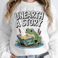 Unearth a Story Frog Reading a Book Summer 2026 Premium Tri-Blend Unisex Sweatshirt Unearth a Story Frog Reading a Book Summer 2026 Premium Tri-Blend Unisex Sweatshirt
