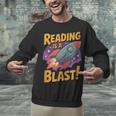 Book Lover Kids And Adults Reading Is a Blast Rocket Ship Unisex Sweatshirt