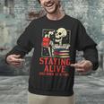 Staying Alive One Book At A Time Skeleton Reading Librarian Unisex Sweatshirt Staying Alive One Book At A Time Skeleton Reading Librarian Unisex Sweatshirt