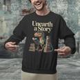 Unearth A Story Dinosaur Reading a Library Book Unisex Sweatshirt