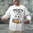 Unearth a Story Cute Dinosaur Summer Reading 2026 Dino Book Unisex Sweatshirt Unearth a Story Cute Dinosaur Summer Reading 2026 Dino Book Unisex Sweatshirt