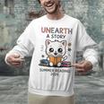 Unearth a Story Cute Kitten Summer Reading 2026 Cat Book Unisex Sweatshirt Unearth a Story Cute Kitten Summer Reading 2026 Cat Book Unisex Sweatshirt