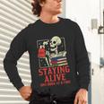 Staying Alive One Book At A Time Skeleton Reading Librarian Unisex Long Sleeve T-Shirt