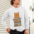 Cute Orange Tabby Cat Reading On Pile Of Books Unisex Long Sleeve T-Shirt Cute Orange Tabby Cat Reading On Pile Of Books Unisex Long Sleeve T-Shirt