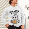 Unearth a Story Cute Dinosaur Summer Reading 2026 Dino Book Unisex Long Sleeve T-Shirt