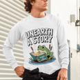 Unearth a Story Frog Reading a Book Summer 2026 Premium Tri-Blend Unisex Long Sleeve T-Shirt