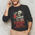 Staying Alive One Book At A Time Skeleton Reading Librarian Unisex Long Sleeve T-Shirt