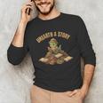 Unearth a Story Dinosaur Reading Books Summer 2026 Unisex Long Sleeve T-Shirt