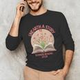 Women's Unearth a Story 2026 Summer Reading Program Flowers Book Unisex Long Sleeve T-Shirt Women's Unearth a Story 2026 Summer Reading Program Flowers Book Unisex Long Sleeve T-Shirt