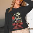 Staying Alive One Book At A Time Skeleton Reading Librarian Unisex Long Sleeve T-Shirt