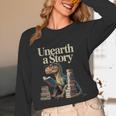 Unearth A Story Dinosaur Reading a Library Book Unisex Long Sleeve T-Shirt Unearth A Story Dinosaur Reading a Library Book Unisex Long Sleeve T-Shirt