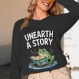 Unearth a Story Frog Reading a Book Summer 2026 Unisex Long Sleeve T-Shirt