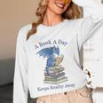 A Book A Day Keeps Reality Away Premium Tri-Blend Unisex Long Sleeve T-Shirt
