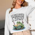 Unearth a Story Frog Reading a Book Summer 2026 Premium Tri-Blend Unisex Long Sleeve T-Shirt