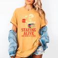 Staying Alive One Book At A Time Skeleton Reading Librarian Women's Comfort Colors T-Shirt Mustard