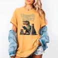 Unearth A Story Dinosaur Reading a Library Book Women's Comfort Colors T-Shirt Mustard