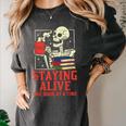Staying Alive One Book At A Time Skeleton Reading Librarian Women's Comfort Colors T-Shirt Pepper