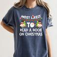 Most Likely To Read A Book On Christmas Snowman Family Women's Comfort Colors T-Shirt Moss