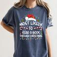 Most Likely To Read A Book Through Christmas Xmas Women's Comfort Colors T-Shirt Moss