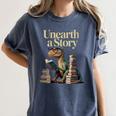 Women's Unearth A Story Dinosaur Reading a Library Book Women's Comfort Colors T-Shirt Moss