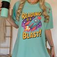 Book Lover Kids And Adults Reading Is a Blast Rocket Ship Women's Comfort Colors T-Shirt Violet Book Lover Kids And Adults Reading Is a Blast Rocket Ship Women's Comfort Colors T-Shirt Violet