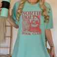 North Pole Book Club Christmas Women's Comfort Colors T-Shirt Violet North Pole Book Club Christmas Women's Comfort Colors T-Shirt Violet