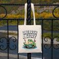 Unearth a Story Frog Reading a Book Summer 2026 Premium Tri-Blend Canvas Tote Bag Unearth a Story Frog Reading a Book Summer 2026 Premium Tri-Blend Canvas Tote Bag