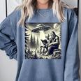 Bigfoot With Alien Reading A Book Bigfoot And UFO Comfort Colors Sweatshirt Denim