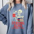 Staying Alive One Book At A Time Skeleton Reading Librarian Comfort Colors Sweatshirt Denim