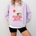 Staying Alive One Book At A Time Skeleton Reading Librarian Comfort Colors Sweatshirt Crimson